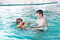 Little kid boy and his father swimming in an indoor pool Royalty Free Stock Photo