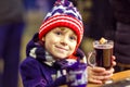 Little kid boy with hot chocolate on Christmas market Royalty Free Stock Photo