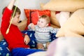 Little kid boy hugging with newborn baby girl, cute sister. Brother on background Royalty Free Stock Photo