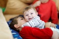 Little kid boy hugging with newborn baby girl, cute sister. Brother on background Royalty Free Stock Photo