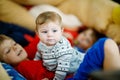 Little kid boy hugging with newborn baby girl, cute sister. Siblings. Brother on background. Kids bonding. Family of Royalty Free Stock Photo