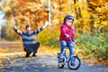 Little kid boy learning moving on bicycle. His father teaching his son biking. Happy man and child. Active family Royalty Free Stock Photo