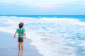 Little kid boy looking on sunset on the beach of ocean Royalty Free Stock Photo