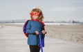 Little kid boy plays superhero. Child on scooter in park. Kids learn to skate roller board. Little boy skating. Royalty Free Stock Photo