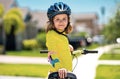 Little kid boy ride a bike in the park. Kid cycling on bicycle. Happy smiling child in helmet riding a bike. Boy start Royalty Free Stock Photo
