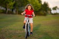 Little kid boy riding a bike in summer park. Child drive a bike on a driveway outside. Kid riding bikes in the city Royalty Free Stock Photo