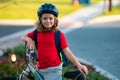 Little kid boy riding a bike in summer park. Child drive a bike on a driveway outside. Kid riding bikes in the city Royalty Free Stock Photo