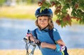 Little kid boy riding a bike in summer park. Child drive a bike on a driveway outside. Kid riding bikes in the city Royalty Free Stock Photo