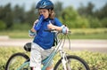 Little kid boy riding a bike in summer park. Child drive a bike on a driveway outside. Kid riding bikes in the city Royalty Free Stock Photo