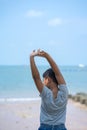 Little kid boy stand on beach and  stretch oneself Royalty Free Stock Photo