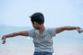 Little kid boy stand on beach and  stretch oneself Royalty Free Stock Photo