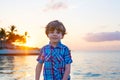 Little kid boy at sunset near ocean Royalty Free Stock Photo