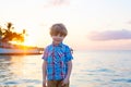 Little kid boy at sunset near ocean Royalty Free Stock Photo