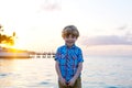 Little kid boy at sunset near ocean Royalty Free Stock Photo