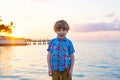 Little kid boy at sunset near ocean Royalty Free Stock Photo