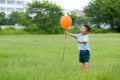 Little kid catch with flying balloon Royalty Free Stock Photo