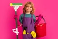 Little kid cleaning at home. Child doing housework having fun. Studio isoalted portrait of child housekeeper with wet