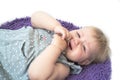 Little kid crying lying on floor. Little cute girl in gray dress is capricious lying on the floor. Portrait of crying child Royalty Free Stock Photo