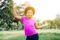Little kid dancing and listening to music in green park Royalty Free Stock Photo