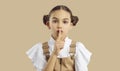 Beautiful little girl puts her finger on her lips and asks you to keep her secret Royalty Free Stock Photo