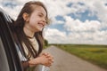 Little kid dreaming from an open car window while travelling. Summer trip with family Royalty Free Stock Photo