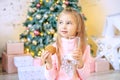 Little kid drinks milk and eats oatmeal cookies. Breakfast. Concept New Year, Merry Royalty Free Stock Photo