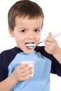 Little kid eating yoghurt Royalty Free Stock Photo