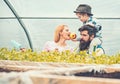 Little kid feeding his mum with bright red and yellow apple while sitting on daddys shoulders. Beaded man with his wife Royalty Free Stock Photo