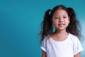 Little kid girl beautiful smile happiness portrait looking at the camera on green background with copy space Royalty Free Stock Photo
