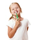 A little kid girl is brushing her teeth with a toothbrush. The concept of daily hygiene. Isolated on white background Royalty Free Stock Photo