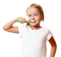 A little kid girl is brushing her teeth with a toothbrush. The concept of daily hygiene. Isolated on white background Royalty Free Stock Photo