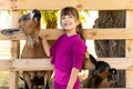 Little kid girl with domestic goat. Zoo, farm, love animal concept. Royalty Free Stock Photo