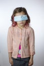 Little kid girl with the eyes closed by mask during coronavirus epidemy