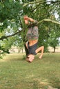 Little kid - girl hanging on branch