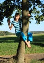 Little kid - girl hanging on trunk