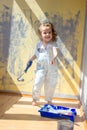 Little kid girl helping making renovation at house room. Royalty Free Stock Photo