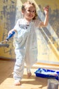 Little kid girl helping making renovation at house room. Royalty Free Stock Photo