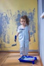 Little kid girl helping making renovation at house room. Royalty Free Stock Photo