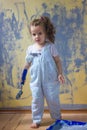 Little kid girl helping making renovation at house room. Royalty Free Stock Photo