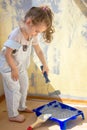 Little kid girl helping making renovation at house room. Royalty Free Stock Photo