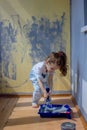 Little kid girl helping making renovation at house room Royalty Free Stock Photo