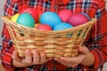 Little kid girl holding a basket of Easter eggs. Close-up Royalty Free Stock Photo