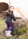 Little kid - girl playing with stump