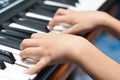 Little kid hand playing keyboard