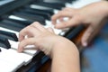 Little kid hand playing keyboard close-up