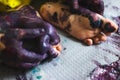 Little kid hands and feet covered with multiple colours