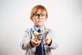 Little kid holding shopping trolley with money. Child is ready for shopping. Holidays, sales and discounts Royalty Free Stock Photo