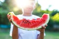 Little kid holding watermelon slice in sunset Royalty Free Stock Photo
