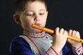 Little kid looking at wooden flute Royalty Free Stock Photo