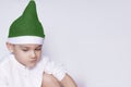 A little kid making a funny annoyed face. Annoyed Christmas Boy in Santa Hat. A really serious and handsome kid Royalty Free Stock Photo